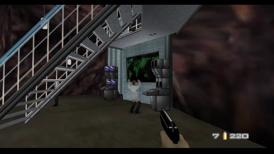 James Bond aiming a PP7 near a scientist and computer consoles in GoldenEye 007 Caverns